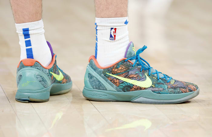 View of green and yellow Nike Kobe shoes.